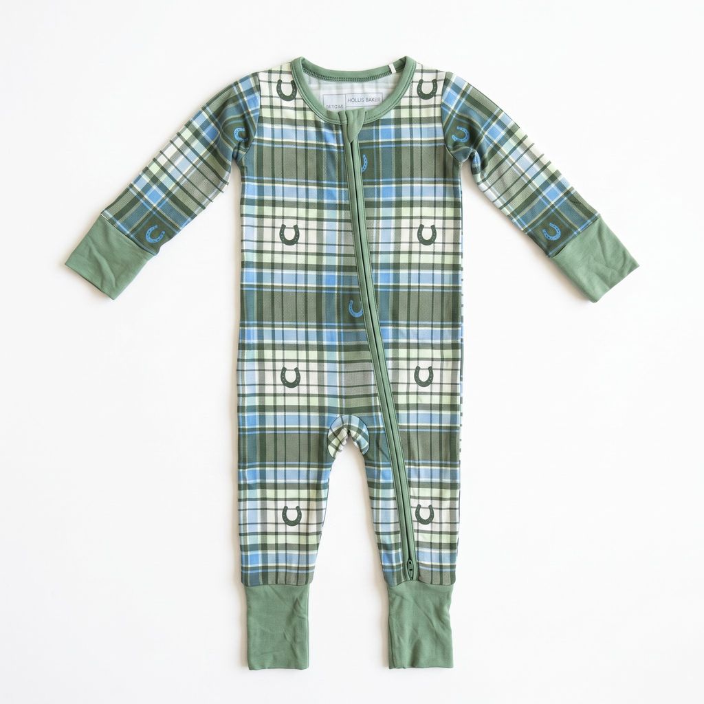 A baby long-sleeve footless sleeper with a green, blue, and white plaid pattern, featuring small horseshoe prints and solid sage green cuffs and leg cuffs, laid flat on a white background.