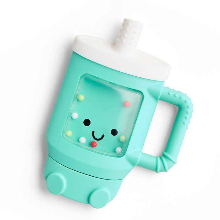A mint green and white sippy tumbler with a handle, featuring a clear front window with a cute smiling face made of small colorful beads.