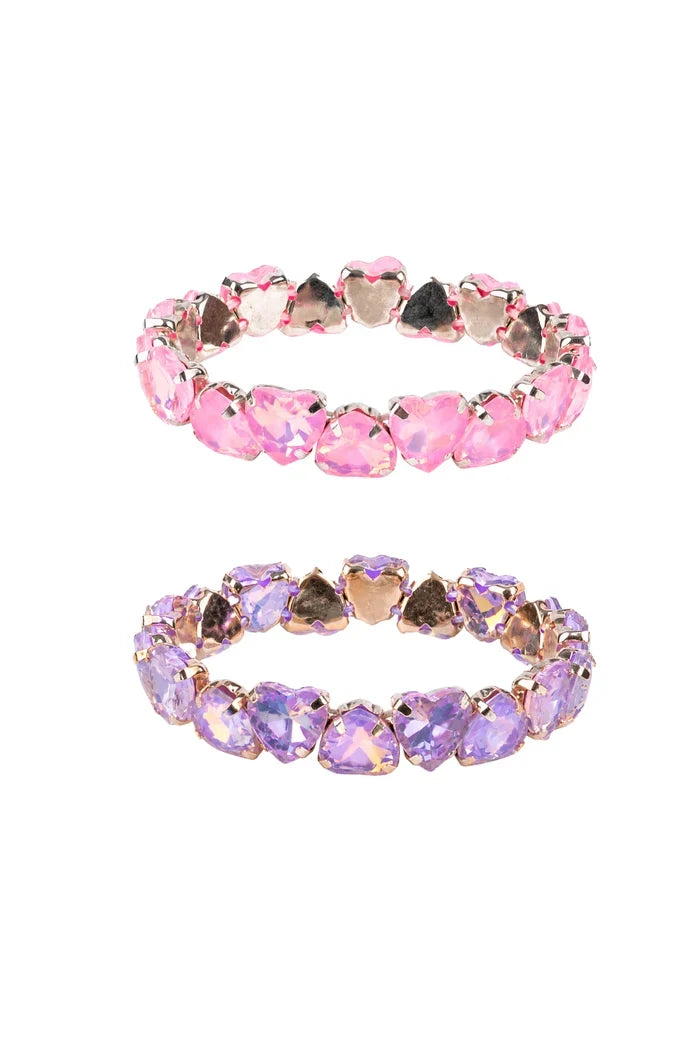 Two heart-shaped crystal stretch bands, one in pink and one in lavender purple, set in rose gold-toned metal, displayed on a clean white background.