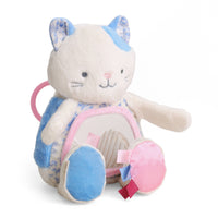 A plush cat-shaped baby backpack toy with a cream-colored body, blue and white patterned accents, a pink interior, and a pink ring handle, shown on a white background.