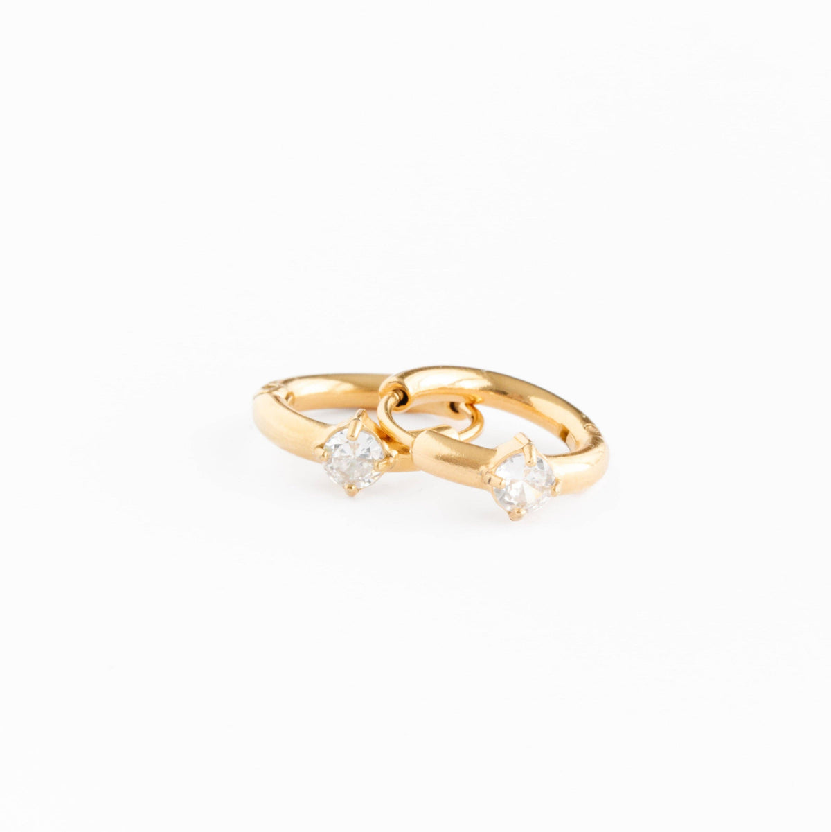 Gold ring with two small diamonds on a white background