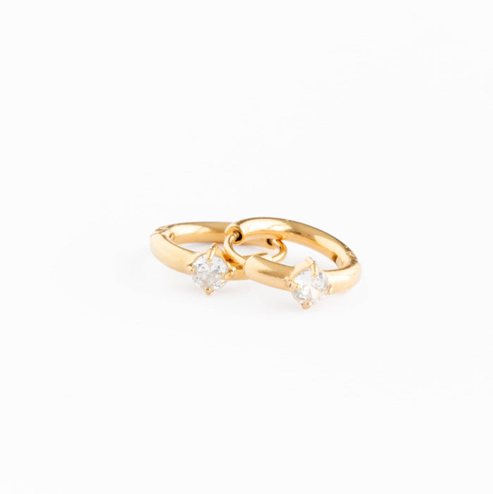 Gold ring with two small diamonds on a white background