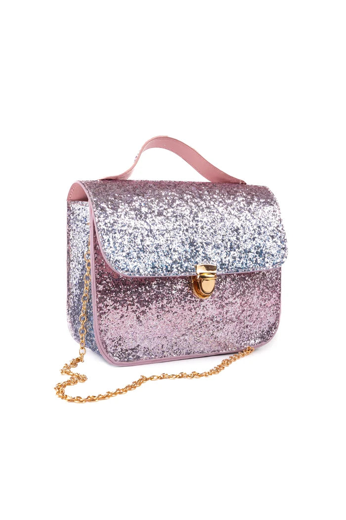 A small square shoulder bag covered in pink and silver glitter, featuring a pink faux-leather handle, a gold clasp, and a gold chain strap, shown on a plain white background.