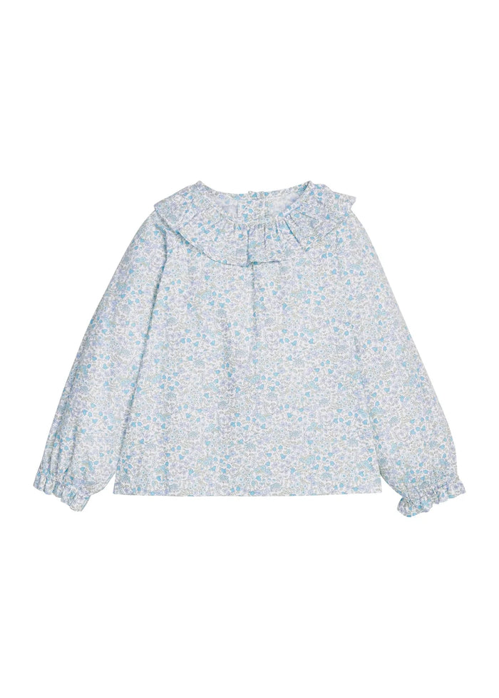 A long-sleeve blouse with a ruffled collar and a light blue and white floral print, displayed flat against a plain white background.