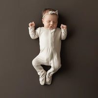 KYTE BABY ZIPPERED FOOTIE IN BISQUE