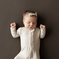 KYTE BABY ZIPPERED FOOTIE IN BISQUE