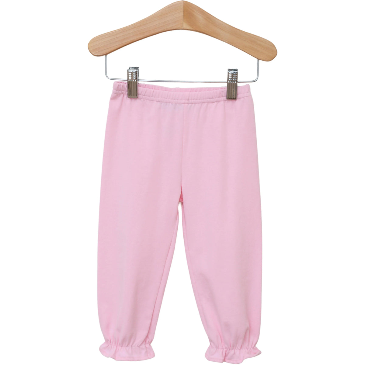 Light pink children's jogger pants with an elastic waistband and gathered ankle cuffs, hanging from a wooden hanger against a plain white background.