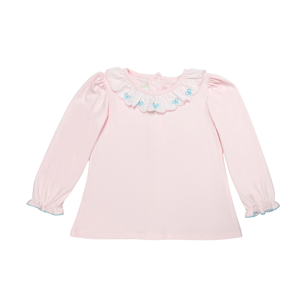 A light pink long-sleeve baby top with a ruffled collar decorated with small blue bows, shown on a plain white background.