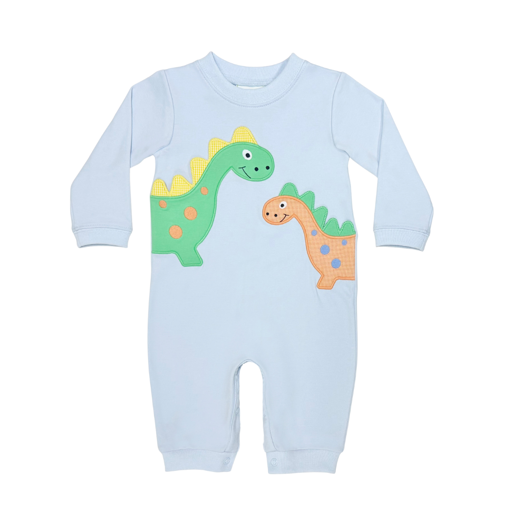 A light blue long-sleeve baby jumpsuit featuring two cartoon dinosaurs on the front, one green and one orange, displayed on a solid white background.