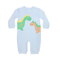 A light blue long-sleeve baby jumpsuit featuring two cartoon dinosaurs on the front, one green and one orange, displayed on a solid white background.