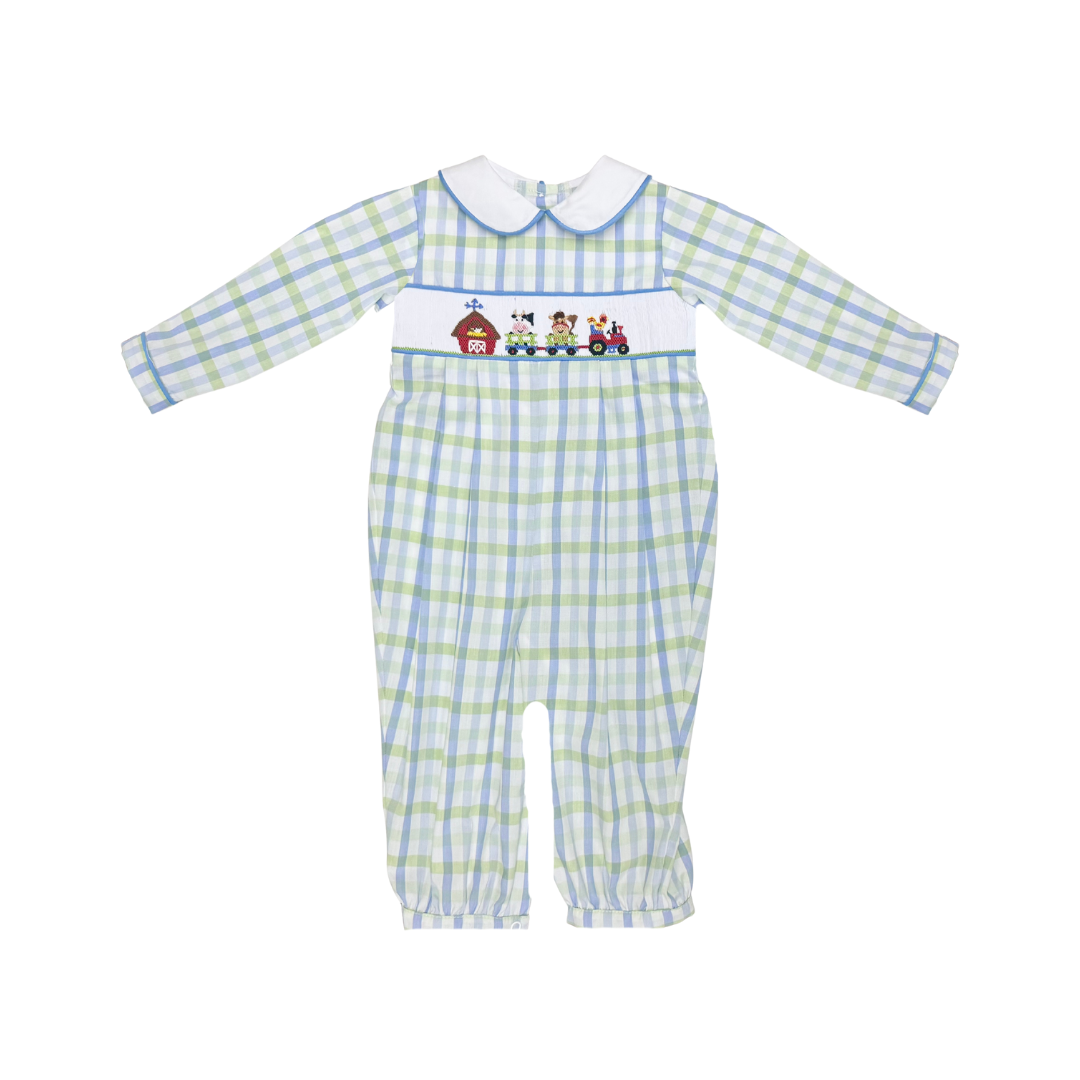 Baby long-sleeve footed romper in a light blue and green plaid pattern, featuring a white Peter Pan collar and a smocked chest panel with cartoon animals and a red barn.