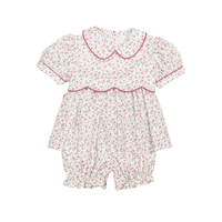 Floral baby romper with a collar on a white background
