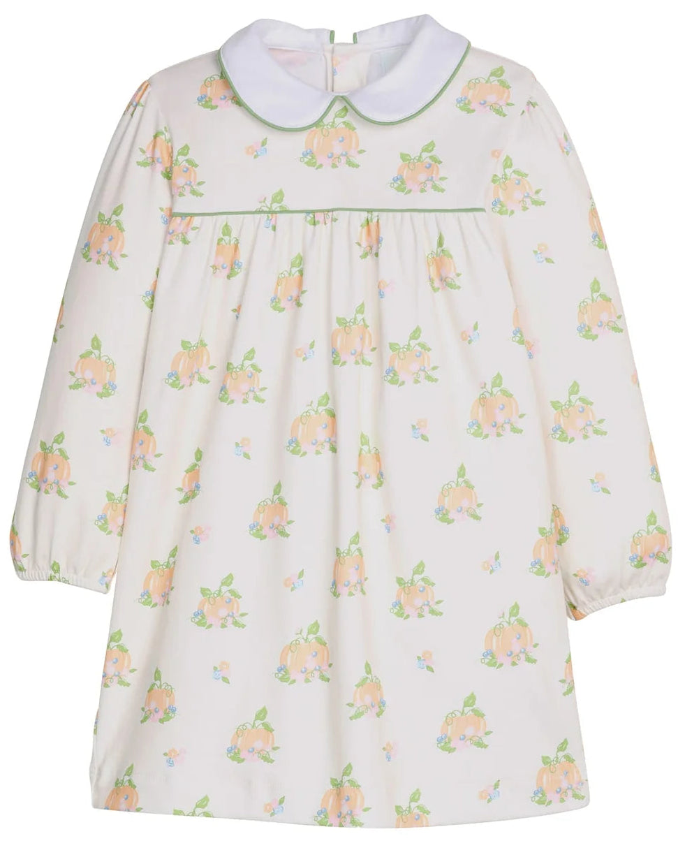 A long-sleeve baby dress with a Peter Pan collar, featuring a cream-colored fabric with a repeating print of pinkish-orange flowers and green leaves, accented by a thin green horizontal stripe across the chest.