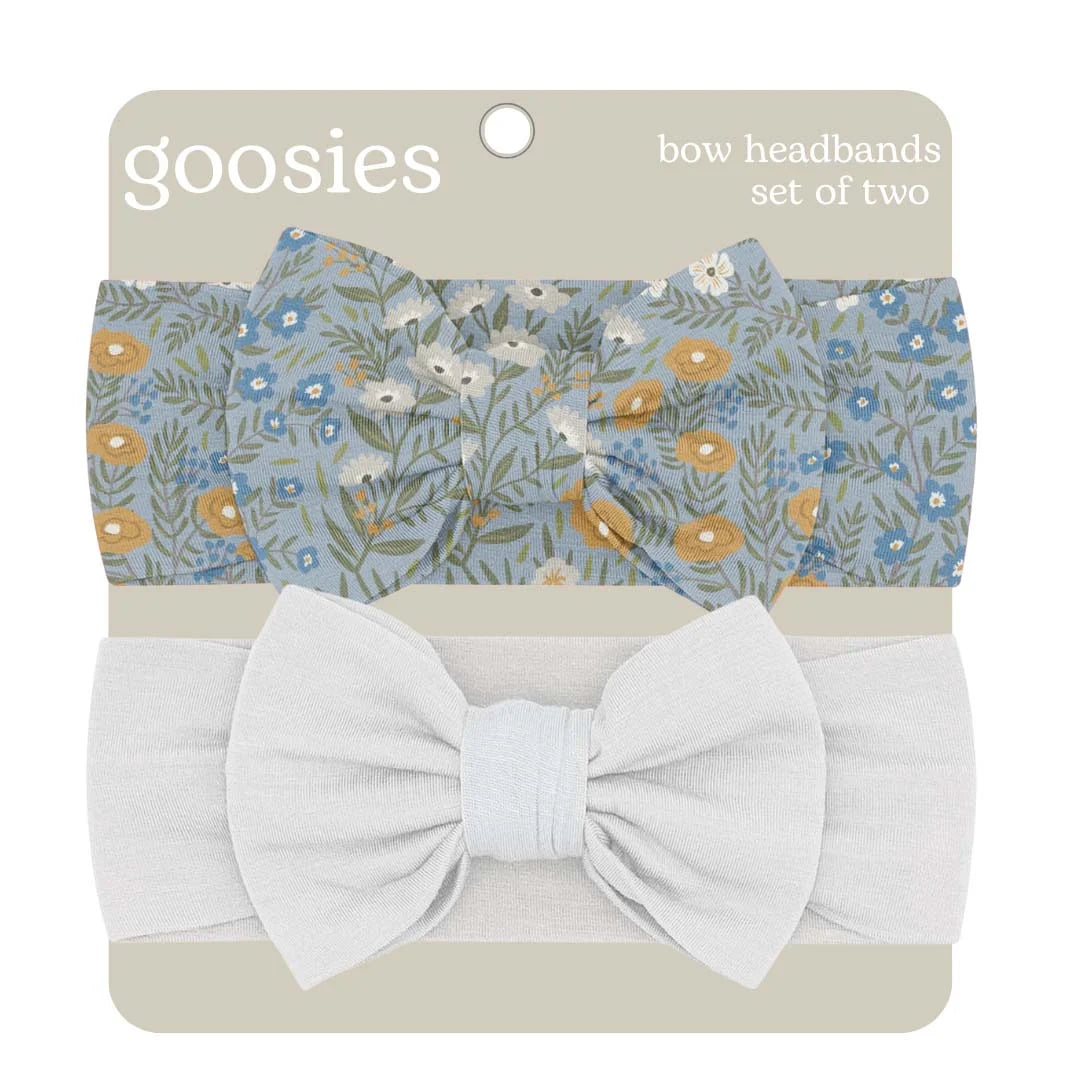 Goosies bow headbands set of two, featuring a light blue floral patterned headband and a solid white headband, both with large bows, on a beige backing card.