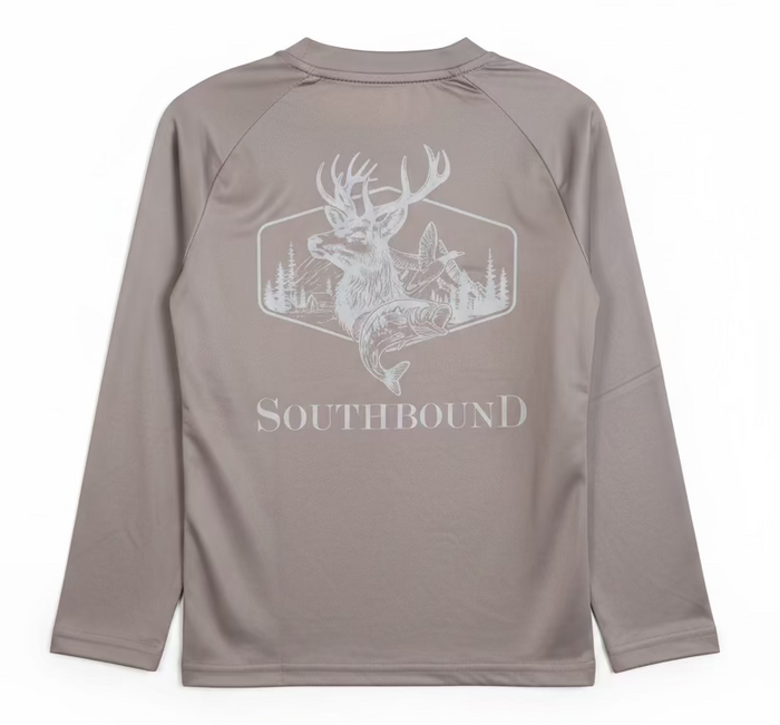 A long-sleeve athletic shirt in taupe-gray with a white graphic of a deer, fox, and mountain on the back, with the word SOUTHBOUND printed below. A hand is holding the hanger up against a home interior background.
