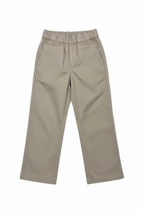 A pair of beige wide-leg cropped pants with an elastic waistband, hanging on a clear plastic hanger in a retail or warehouse setting with shoe boxes stacked on shelves in the background.