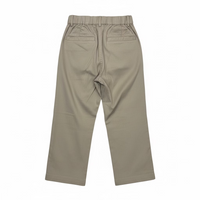 A pair of beige cropped pants with an elastic waistband, hanging on a clear plastic hanger in a retail or warehouse setting with shoe boxes stacked on shelves in the background.