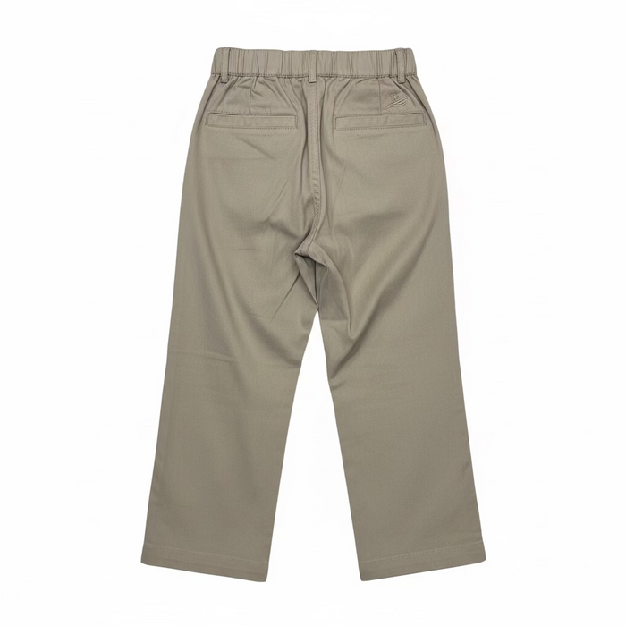 A pair of beige cropped pants with an elastic waistband, hanging on a clear plastic hanger in a retail or warehouse setting with shoe boxes stacked on shelves in the background.