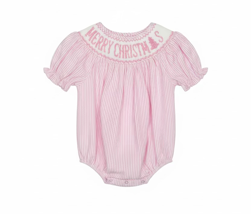A pink and white vertically striped baby romper with 'MERRY CHRISTMAS' embroidered in pink on the white yoke, hanging on a clear hanger in a retail store.