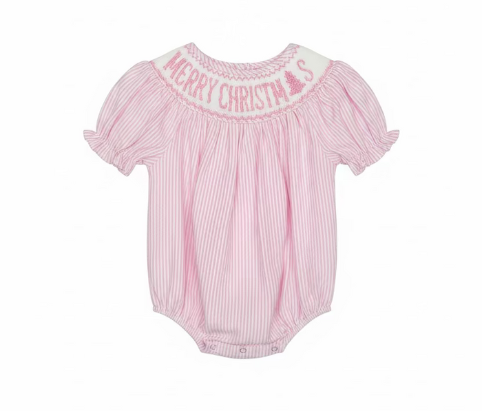 A pink and white vertically striped baby romper with 'MERRY CHRISTMAS' embroidered in pink on the white yoke, hanging on a clear hanger in a retail store.