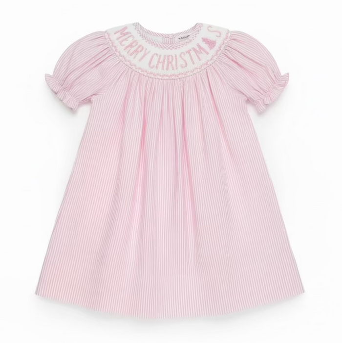 A pink and white vertically striped baby dress with short puff sleeves and 'MERRY CHRISTMAS' embroidered on the yoke, hanging on a clear hanger in a retail store.
