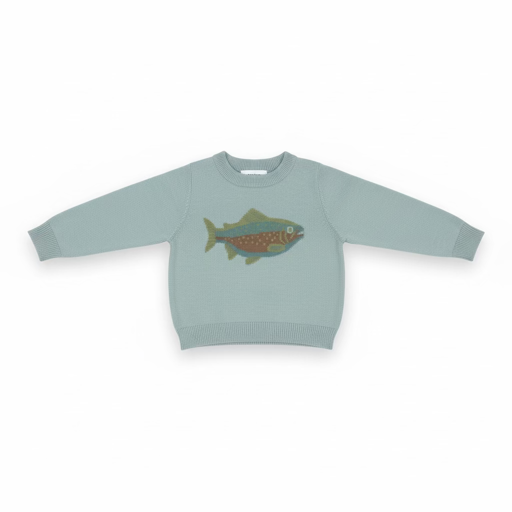 A light sage green knit sweater for toddlers, featuring a colorful fish graphic on the chest, hanging on a clear plastic hanger on a store shelf.