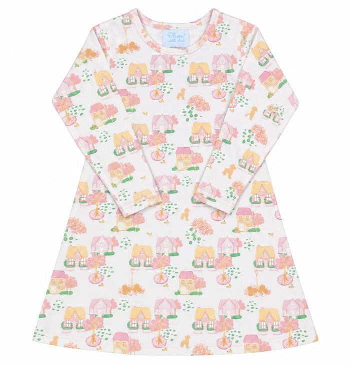A long-sleeve A-line nightgown dress featuring a whimsical, colorful print of houses, trees, and animals on a warm off-light pink background.
