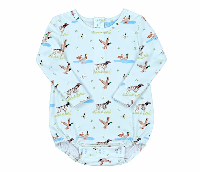 A baby long-sleeve bodysuit in light blue with an all-over duck hunting print featuring ducks, geese, and hunting dogs, laid flat on a white background.