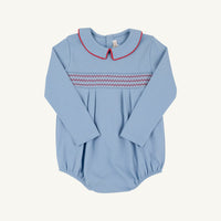 A light blue long-sleeve baby romper with a decorative zigzag smocked chest band in red and white, and a red-trimmed Peter Pan collar, shown flat on a light cream background.