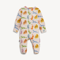 A baby footed sleeper with long sleeves and an all-over colorful dinosaur print on a light pink background, shown against a plain light gray background.