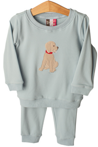 A toddler's two-piece sweatshirt and pants set in a pale sage green, featuring an embroidered puppy on the chest. The set is displayed on a wooden hanger against a plain white background.