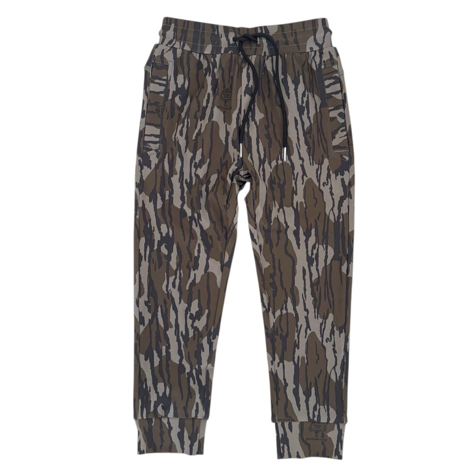 A pair of jogger-style pants featuring an abstract bark-like camouflage pattern in shades of brown, gray, and beige, with a dark drawstring waistband and ribbed cuffs.