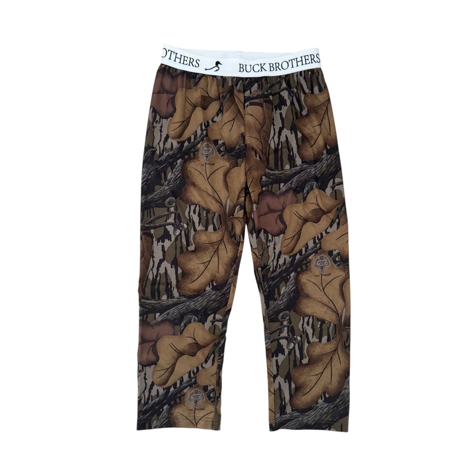 A pair of children's camouflage pants featuring a brown and tan leaf-and-branch woodland pattern, with a white waistband displaying the 'BUCK BROTHERS' brand name.