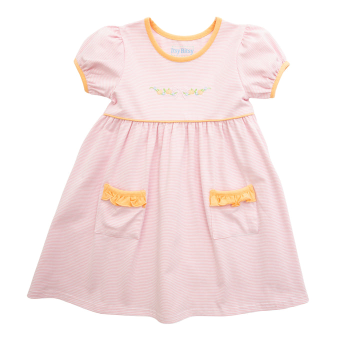 Pink dress with yellow accents on a white background