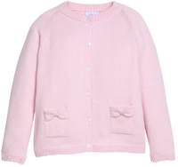 A light pink ribbed knit cardigan sweater with a round neckline, button-front closure, and two front pockets with bow details, shown on a plain white background.