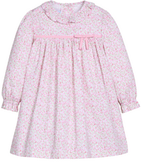 A long-sleeve baby dress with a delicate pink and white floral print, featuring a ruffled Peter Pan collar, gathered waist, and a matching pink ribbon bow at the chest.