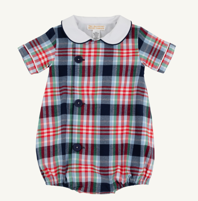 A baby short-sleeve romper with a red, navy, green, and white plaid pattern, featuring a white Peter Pan collar and three dark buttons down the front.