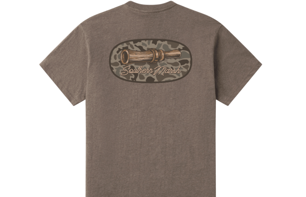 A heather brown short-sleeve t-shirt shown from the back, featuring a large graphic print of a wooden spyglass inside a camouflage oval with 'Southern Marsh' written in script.
