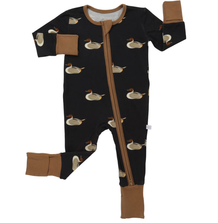 A baby long-sleeve footed sleeper in black with a brown zipper and duck print, featuring solid brown cuffs and elbow patches.