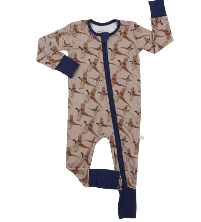 A baby long-sleeve footless sleeper with an allover pheasant pattern on a beige background, featuring solid navy blue trim, cuffs, and a front zipper.