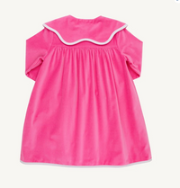 Bright pink short-sleeve dress shown from the back, featuring a wide scalloped collar with white trim and white piping along the hem, photographed on a plain light background.