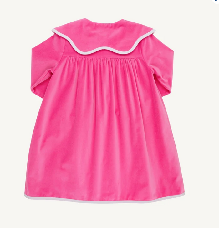 Bright pink short-sleeve dress shown from the back, featuring a wide scalloped collar with white trim and white piping along the hem, photographed on a plain light background.