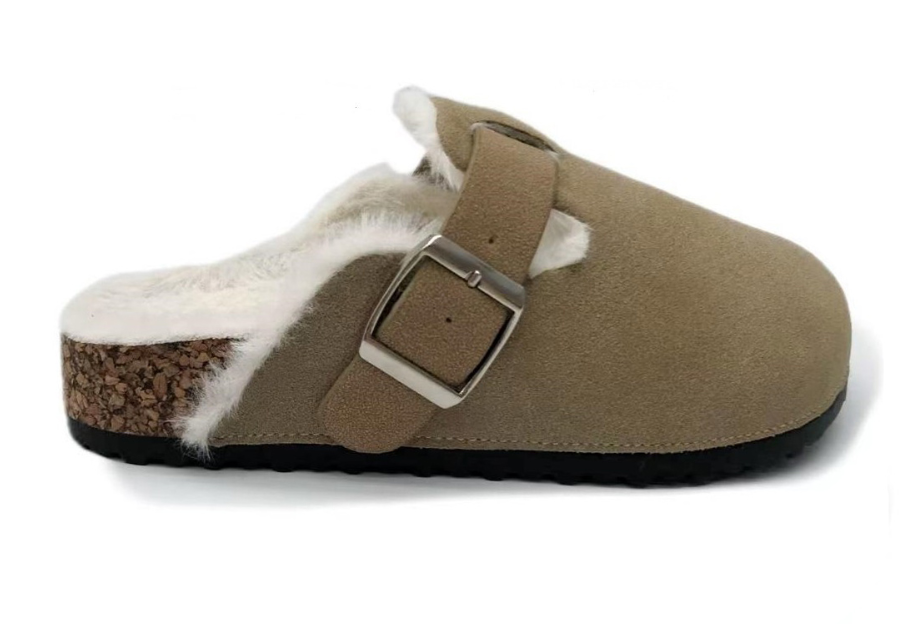 A taupe-brown clog-style slipper with a white faux-fur lining and a silver buckle, shown from the side on a white background.