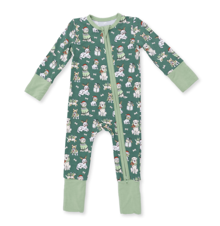 A baby's long-sleeve footless zip-up sleeper in sage green, featuring an all-over print of white dogs wearing Santa hats and scarves, with a solid sage green collar, cuffs, and ankle cuffs.