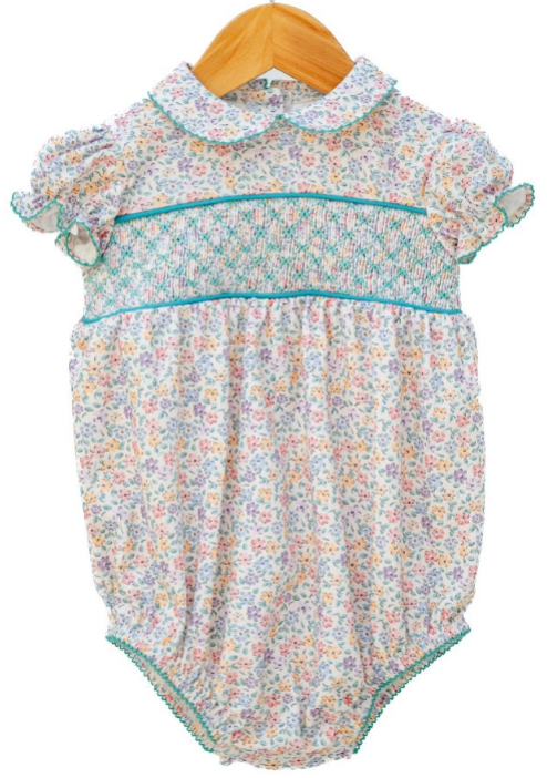 "Ruth & Ralph Aqua Floral Smocked Woven Emmie Bubble — white ditsy floral print baby bubble with teal smocking, piping trim, peter pan collar, and ruffle sleeves, on hanger"