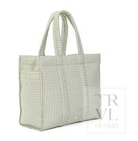 A light sage green and white striped canvas tote bag with dual shoulder straps, shown from a three-quarter angle on a white background with a 'TRVL design' watermark.