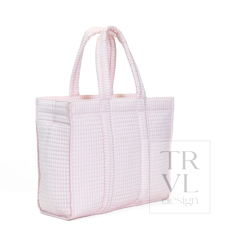 A light pink and white gingham quilted tote bag with two top handles, shown from a three-quarter angle on a white background with a 'TRVL design' watermark.