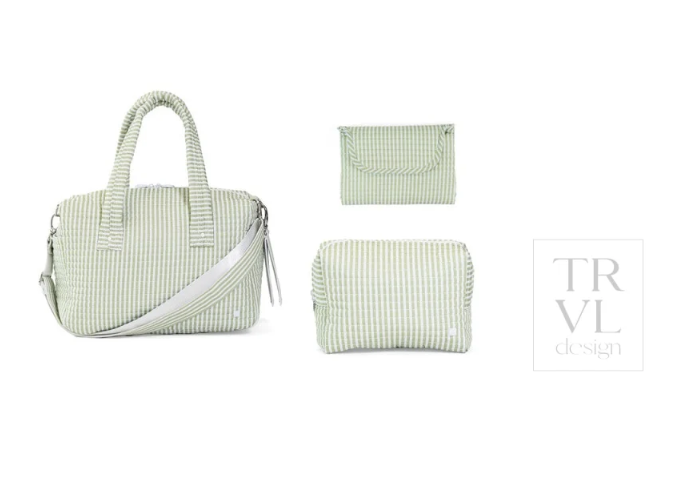A light green and white striped fabric bag set by TRVL design, featuring a main handbag with dual top handles and a shoulder strap, a small zip pouch, and a larger rectangular pouch, all on a white background.