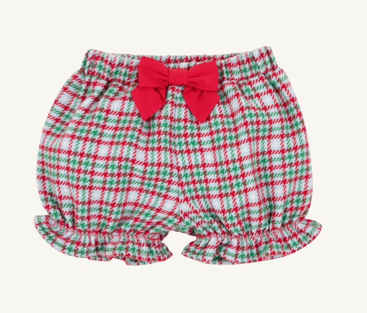 A pair of baby bloomers with a red, green, and white plaid pattern, featuring a large red bow at the waistband and ruffled hems, shown against a plain off-white background.