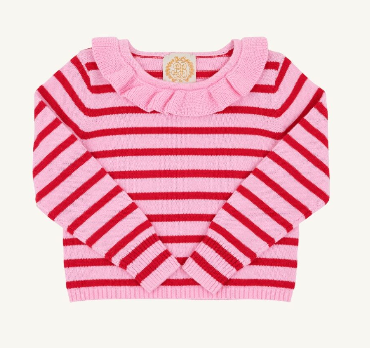A pink and red striped knit sweater for toddlers, featuring a ruffled collar and long sleeves, laid flat against a light cream background.